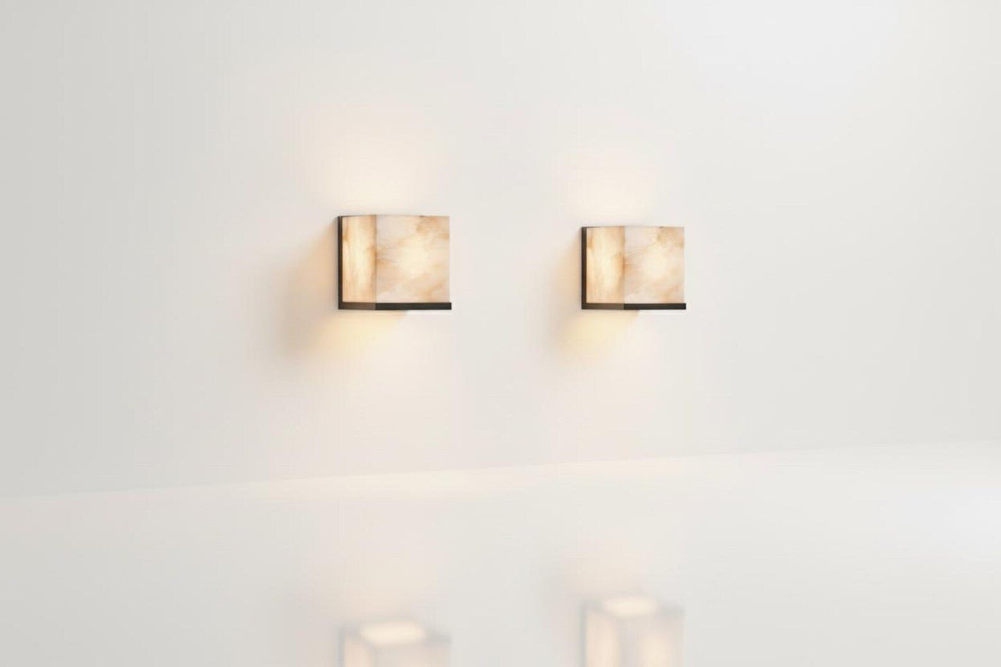 Two wall-mounted lights on a white wall