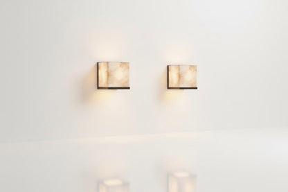Two wall-mounted lights on a white wall