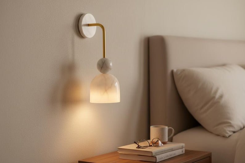 Alabaster wall sconce with brass arm used as bedroom wall lighting