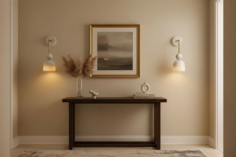 Alabaster wall sconce with brass arm in refined interior setting