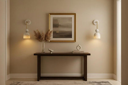 Alabaster wall sconce with brass arm in refined interior setting