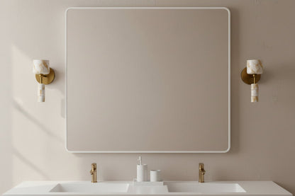 Alabaster wall sconces with brass finish installed in bathroom providing soft diffused lighting
