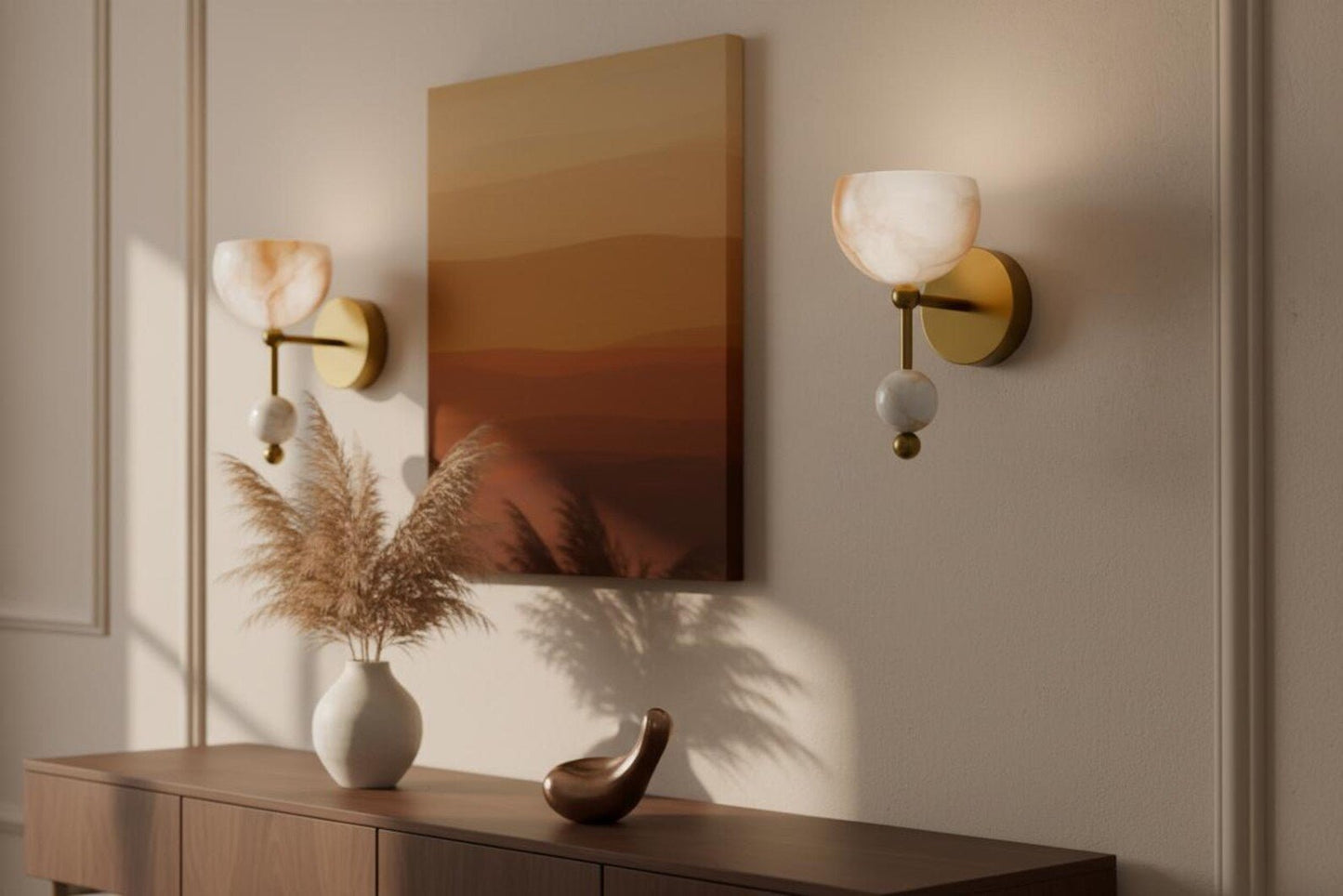 Decorative wall sconces with a mirror and vase on a wooden console table.