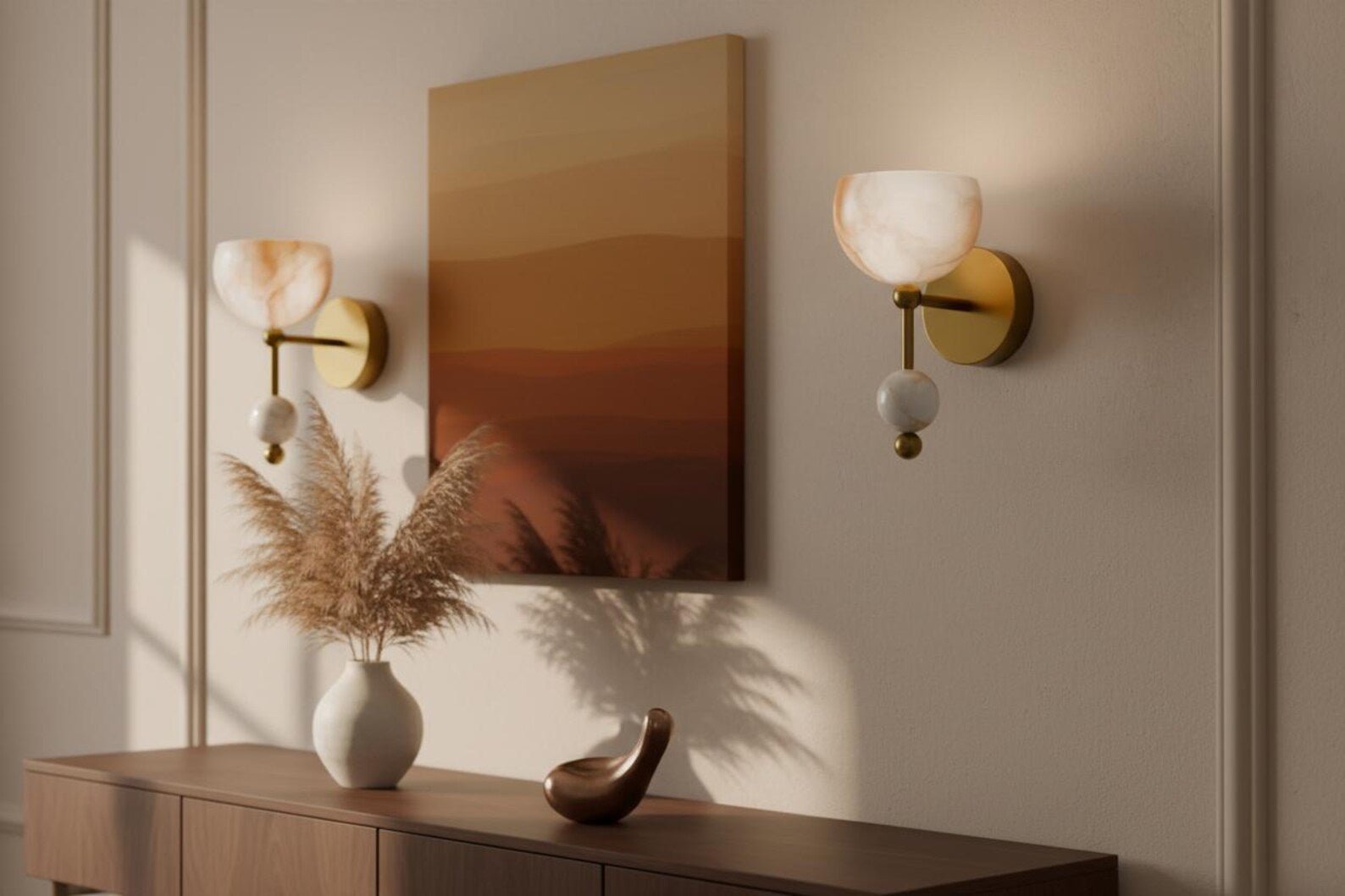Decorative wall sconces with a mirror and vase on a wooden console table.