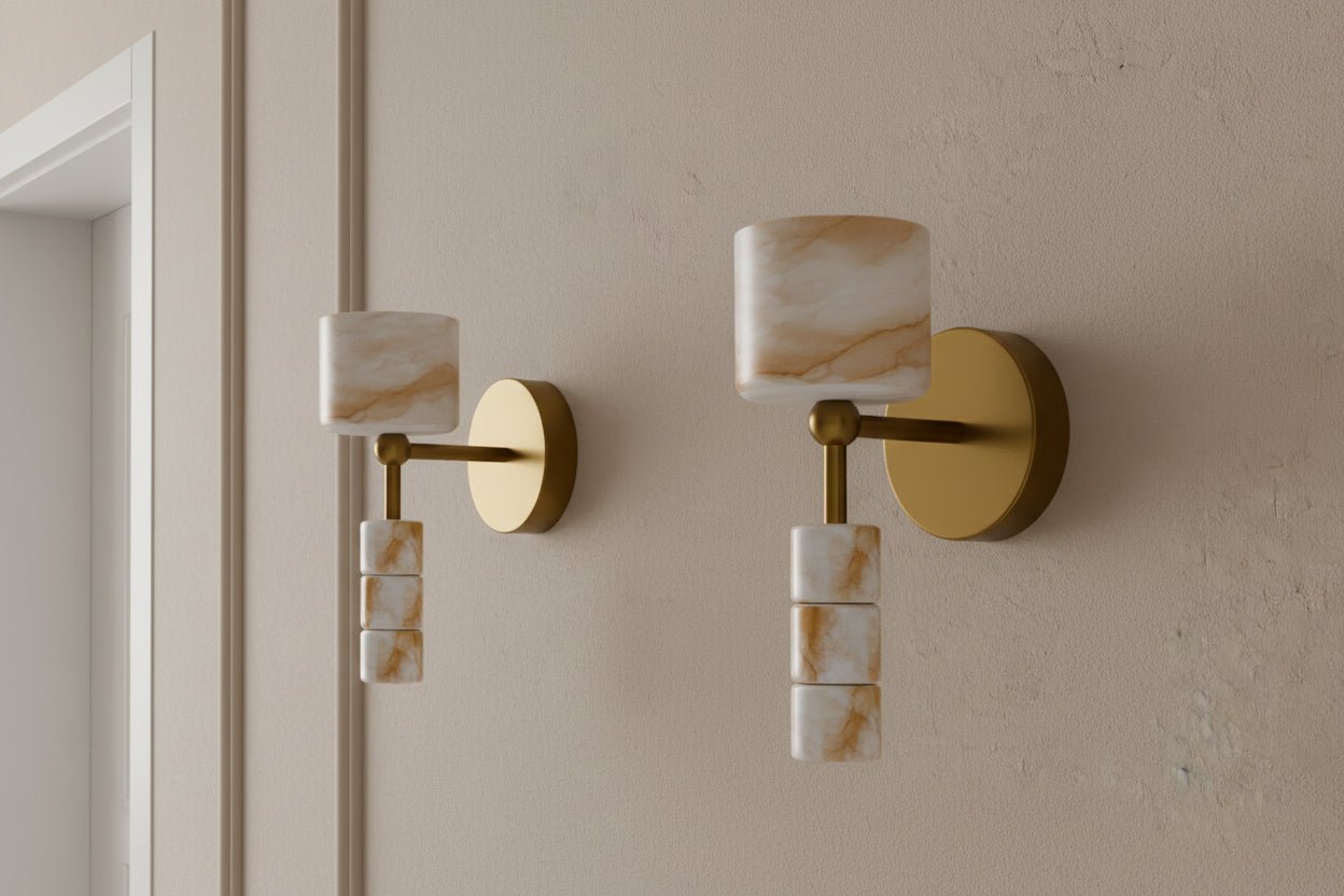 Pair of alabaster wall sconces with brass finish installed symmetrically on interior wall
