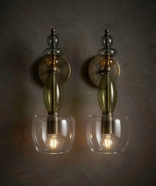 Two wall-mounted sconces with glass shades on a dark background
