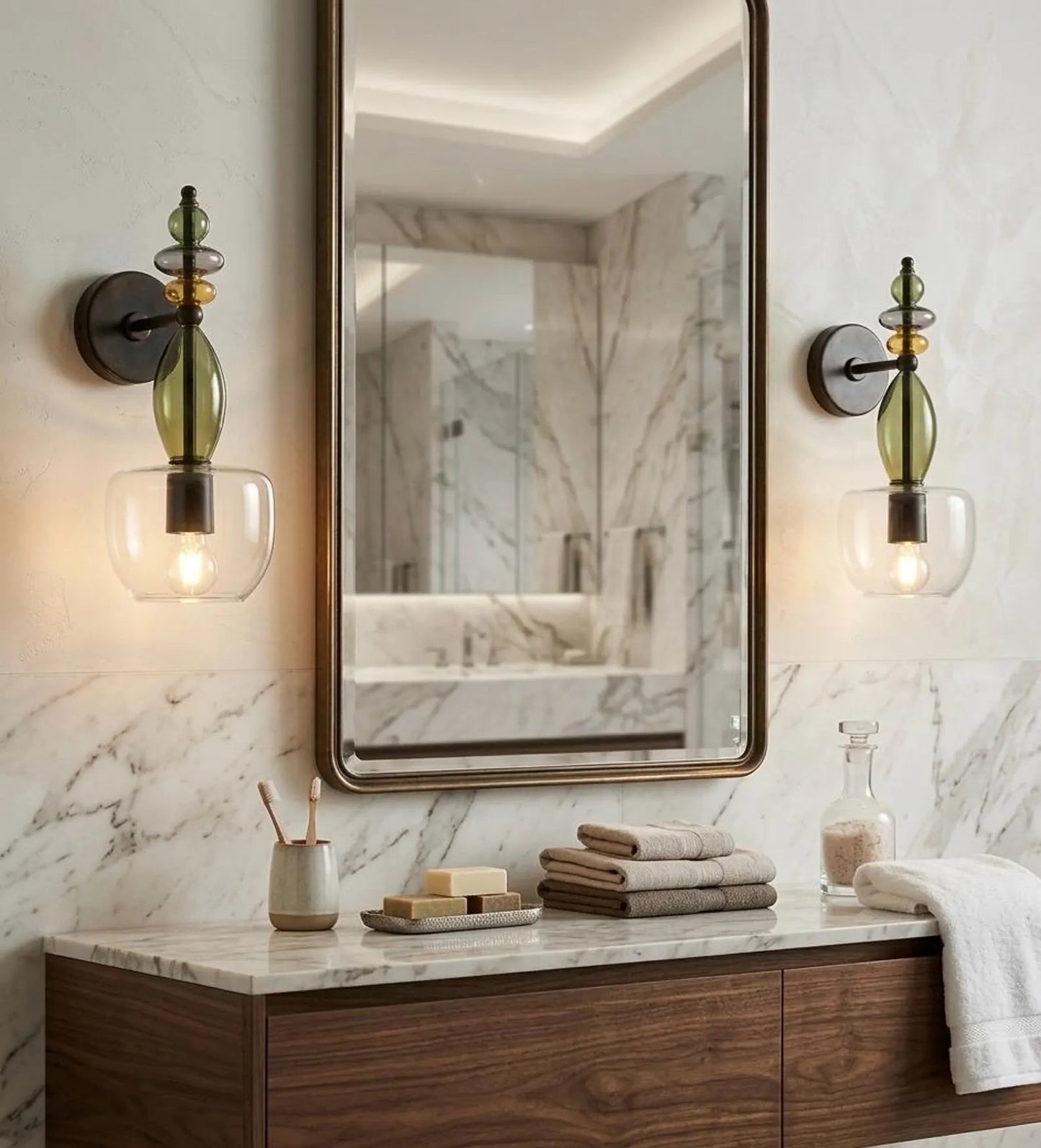 Bathroom vanity with mirror, lights, and toiletries against a marble wall.