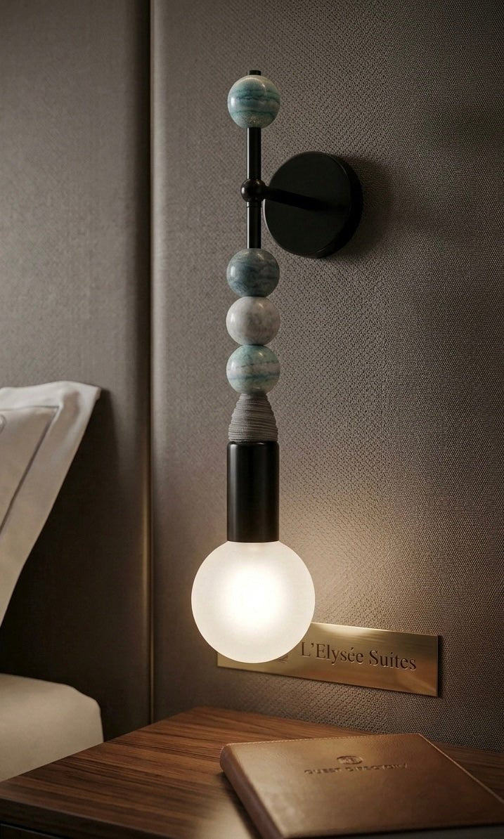 Blue jade stone wall sconce with frosted glass globe, handmade stacked stone wall light fixture, modern wall mounted lighting for  bedside | Les Trois Pyramides