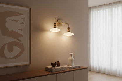 Modern wall sconce with a vase and books on a wooden surface in a room with a window and abstract art.