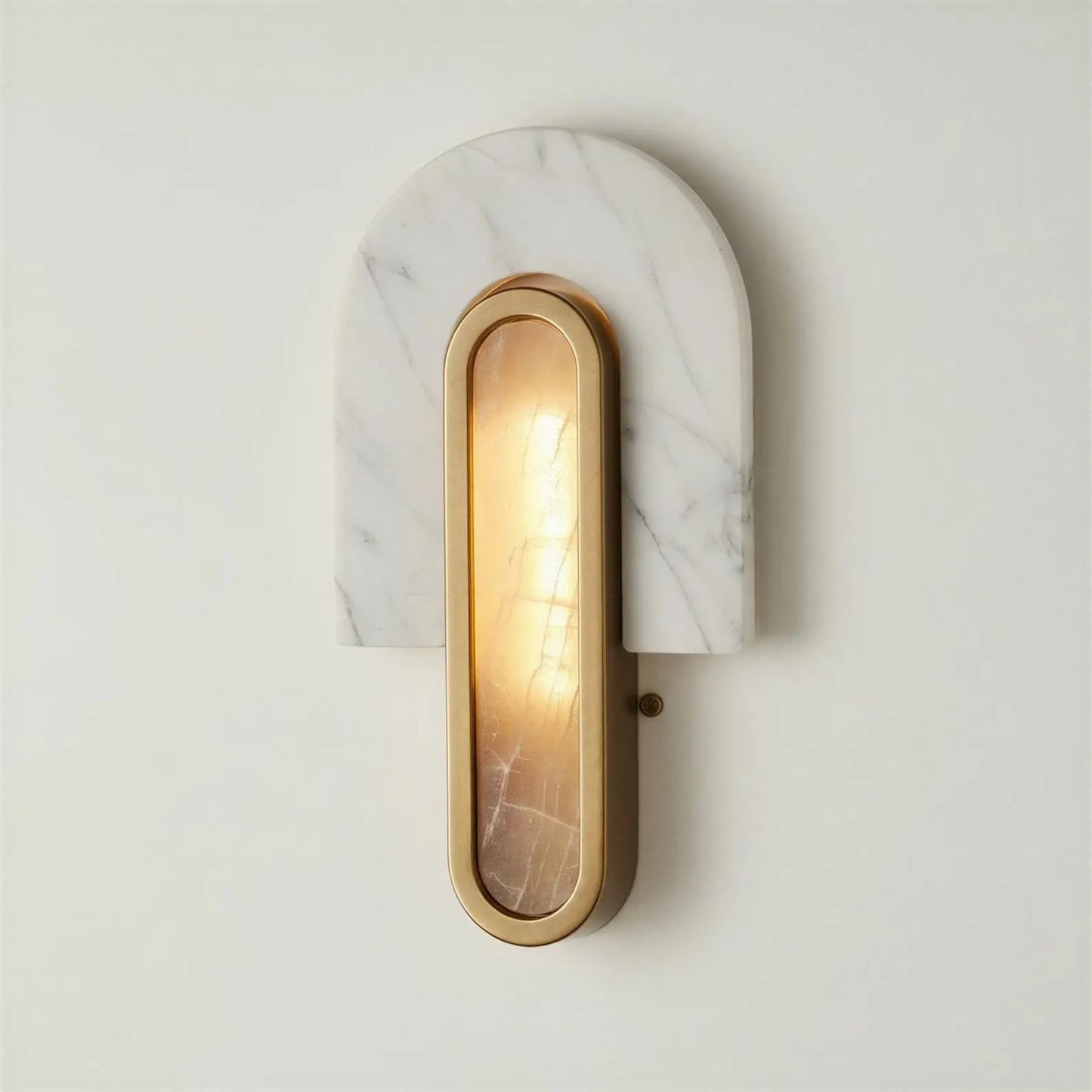 Wall-mounted light fixture with marble-like finish and gold frame on a white wall.