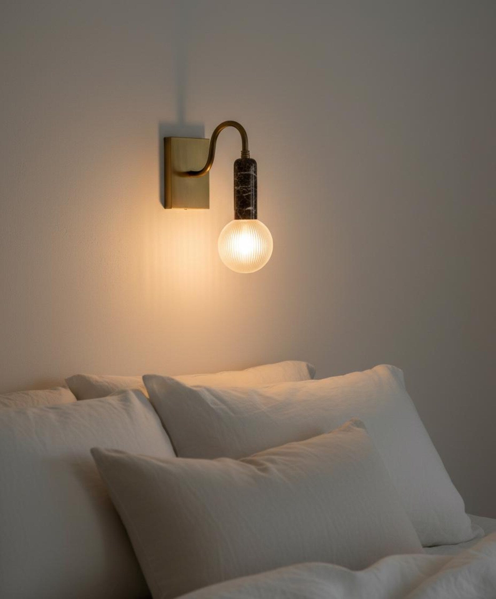 Wall-mounted light fixture casting a warm glow.