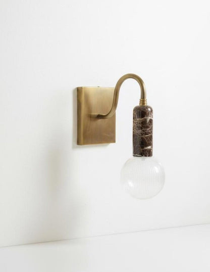 Wall-mounted light fixture with a vintage-style bulb 