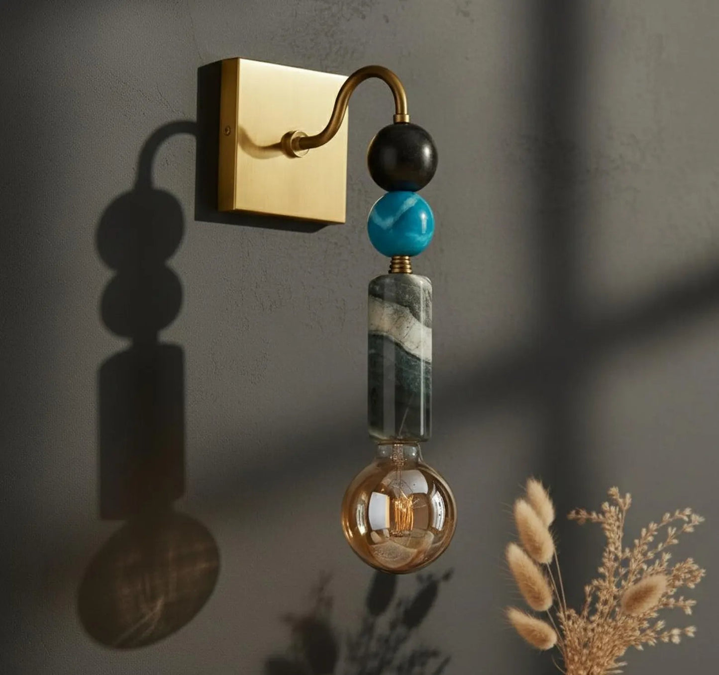 Decorative wall sconce with beads on a dark wall