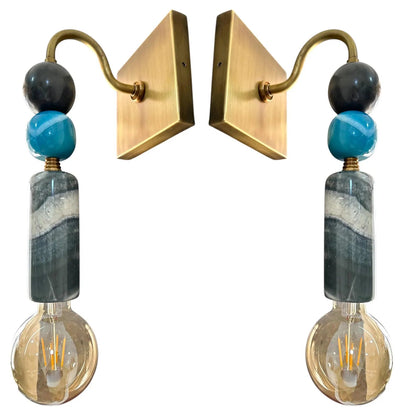 Pair of wall sconces with gold brackets, blue and gray marbled beads, and clear glass bulbs on a white background.