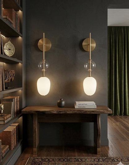 Modern wall sconces with glass shades in a home office setting.