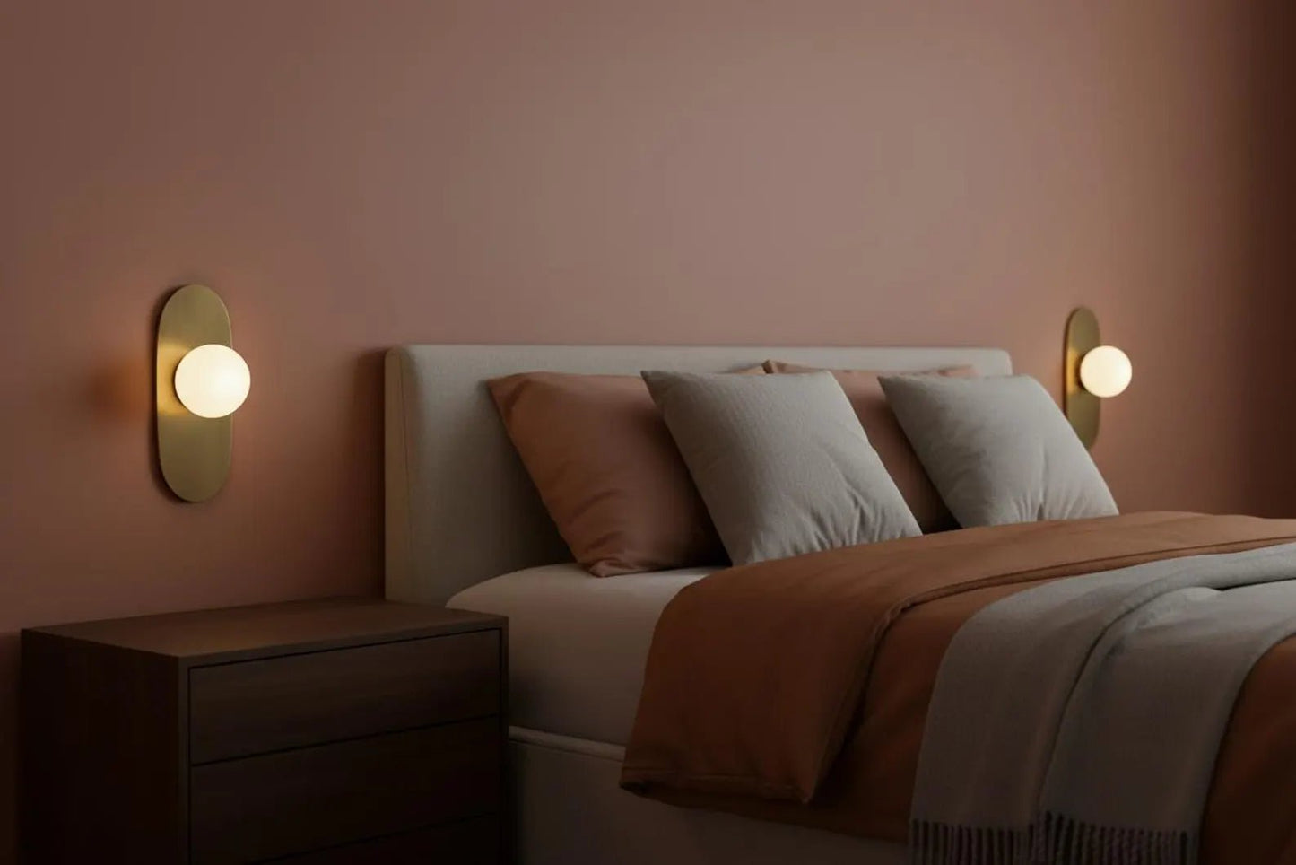 Bedroom with a bed, nightstands, and wall lights on a pink wall.