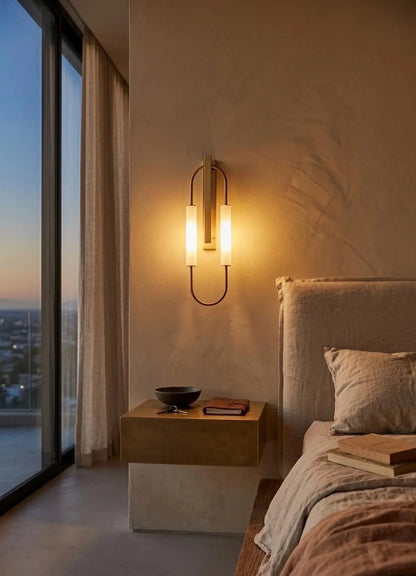 Modern bedroom with wall-mounted light fixture, bed, and city view.