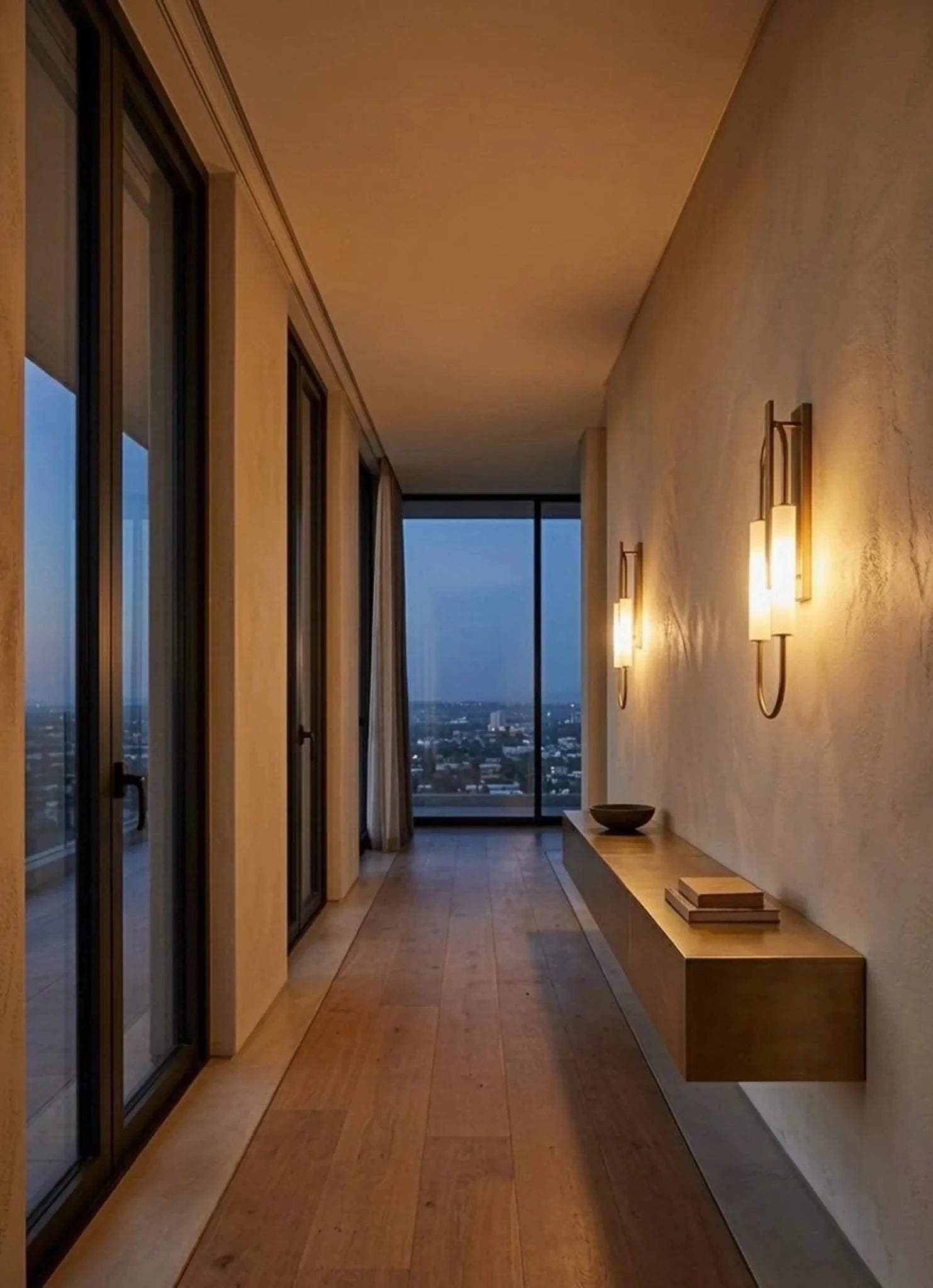 Modern interior hallway with large windows, wooden floor, and wall sconces.