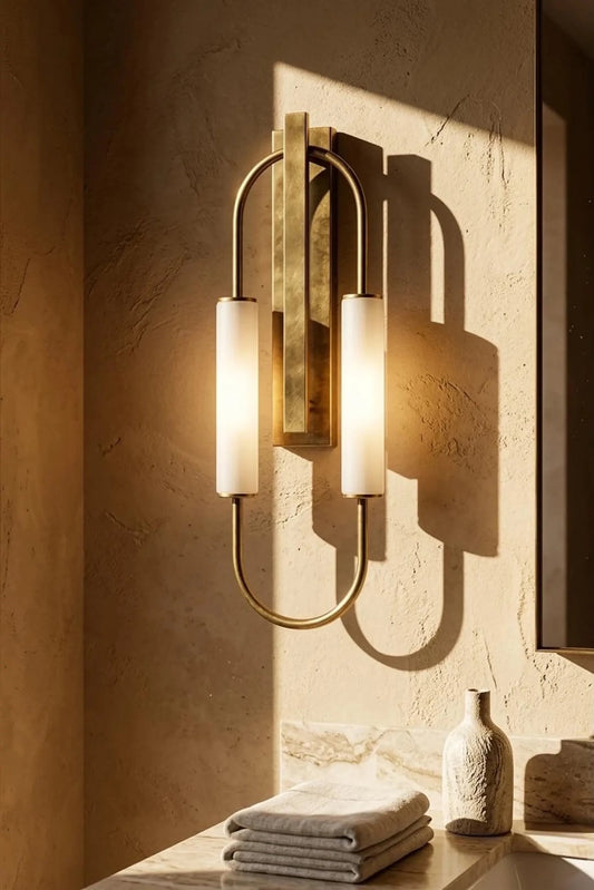 Decorative wall sconce with three cylindrical lights on a textured wall.