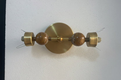Brass wall sconce detail showing onyx stone and metal connections