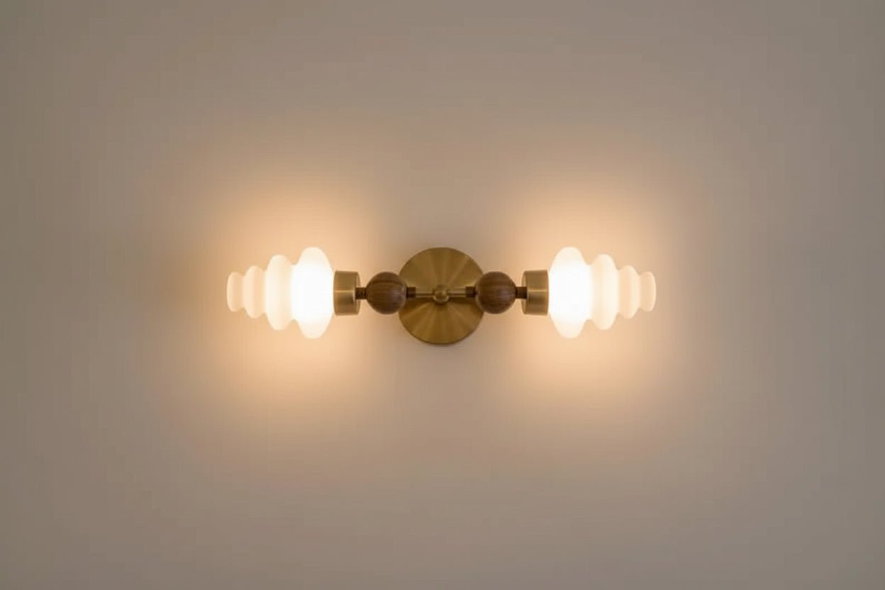 Double brass wall sconce with frosted glass shades and onyx stone details