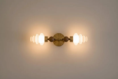 Double brass wall sconce with frosted glass shades and onyx stone details