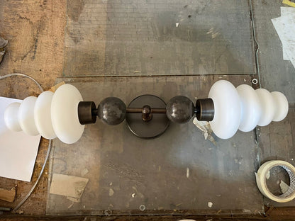 Double brass wall sconce with frosted glass shades and onyx stone details