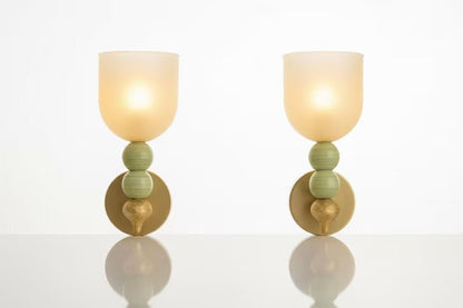 Front view of double onyx stone wall sconces with frosted glass shades
