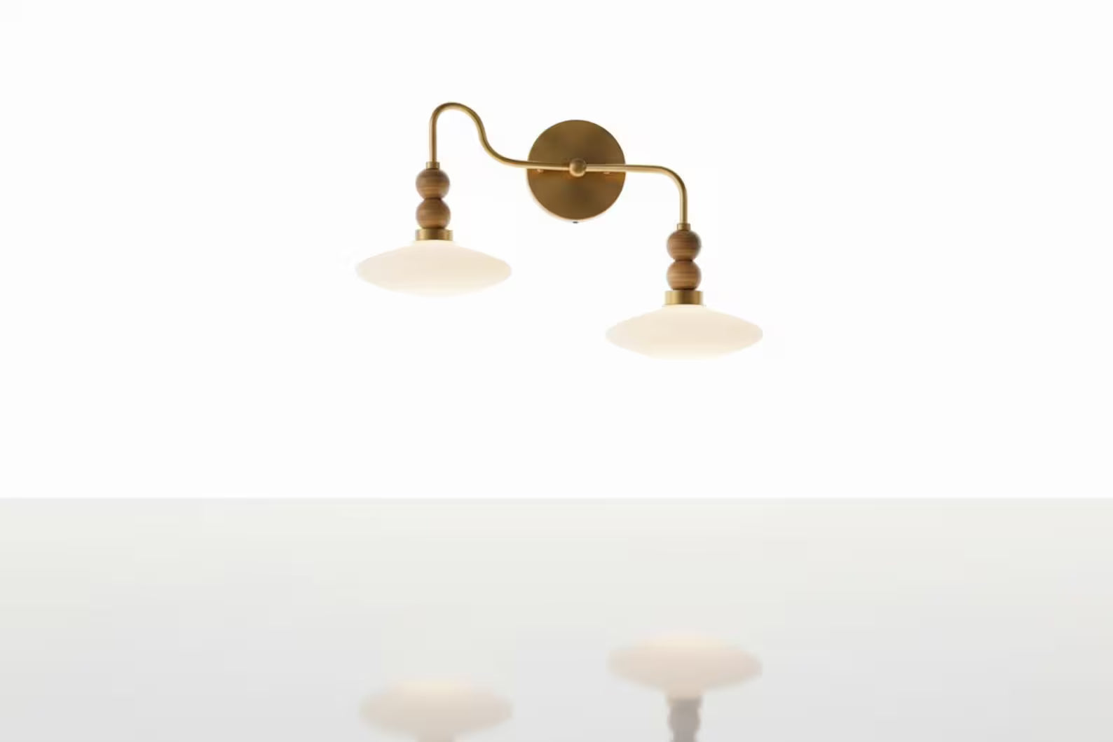 Wall-mounted lamp with two arms on a white background