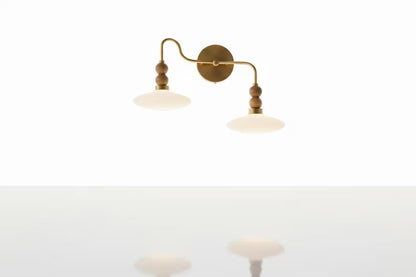 Wall-mounted lamp with two arms on a white background