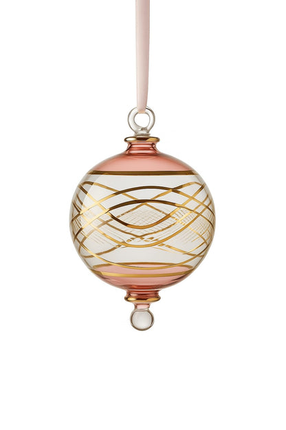Decorative glass ornament with gold swirls on a white background