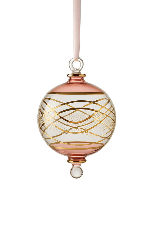 Decorative glass ornament with gold swirls on a white background