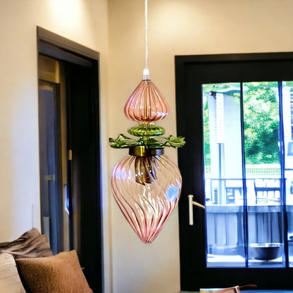 Decorative pendant light hanging in a room with a view of a balcony - Les Trois Pyramides