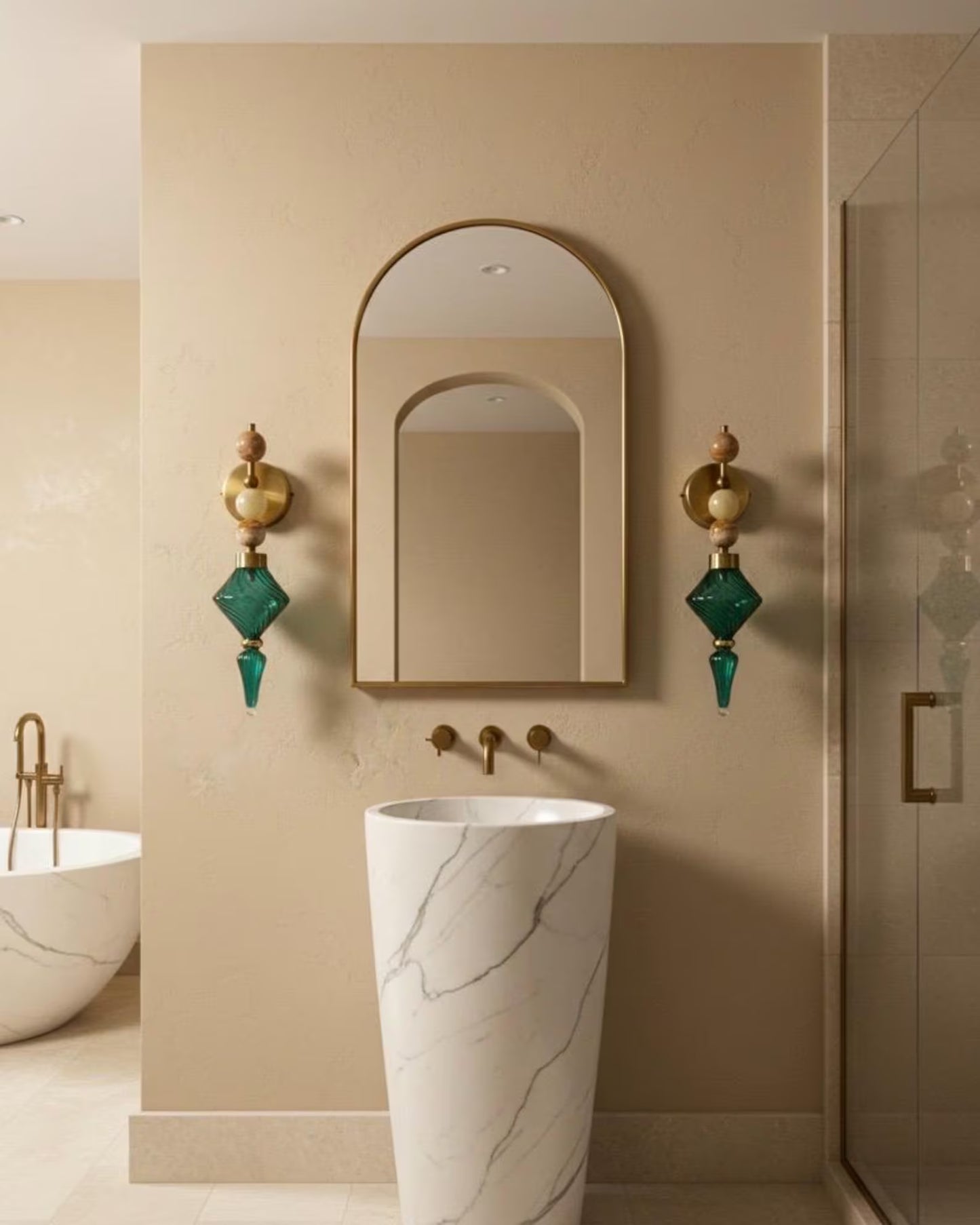 Bathroom interior with a marble sink, decorative mirror, and wall sconces.