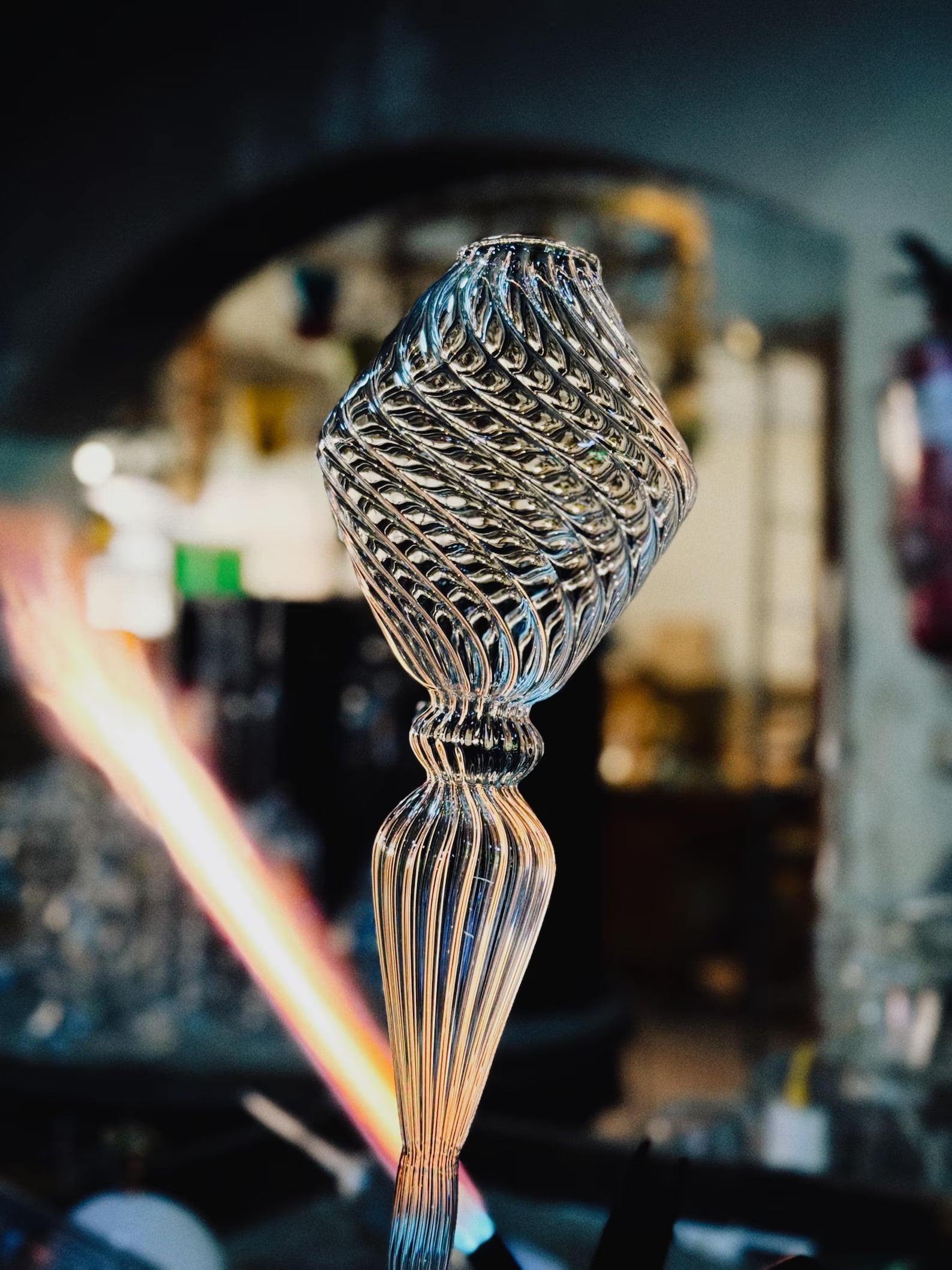Decorative glass object with intricate patterns on a blurred background