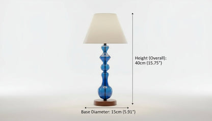 Table lamp with a blue base and beige shade on a white background