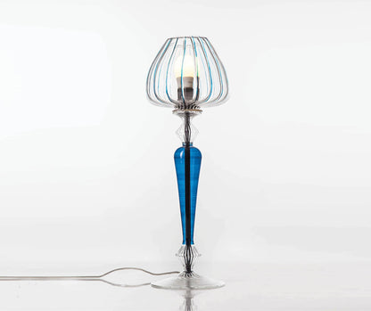 Decorative table lamp with blue and clear glass design on a white background