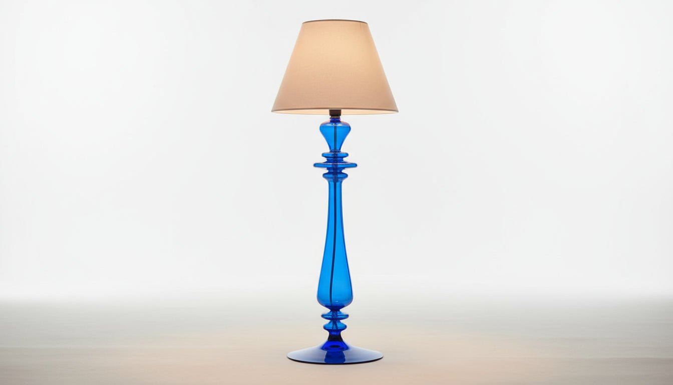Blue lamp with white shade on a table in a room with decor elements.
