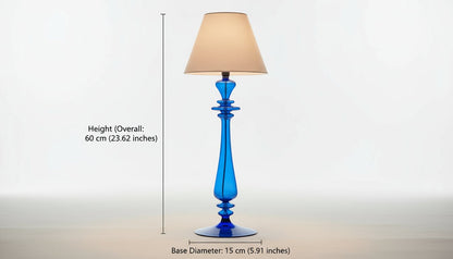Blue glass table lamp with a beige lampshade on a light background
