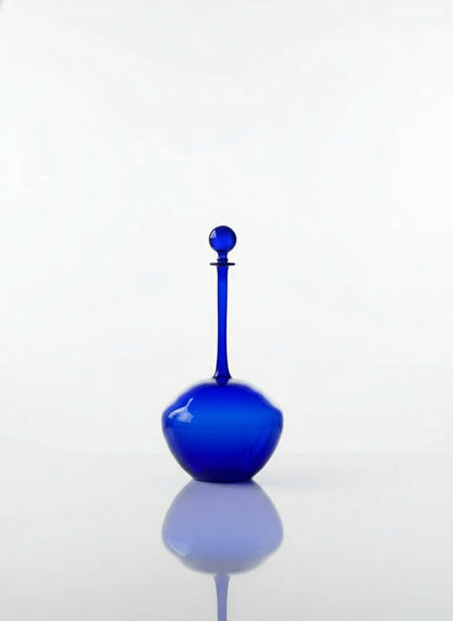 Blue glass decanter on a white background