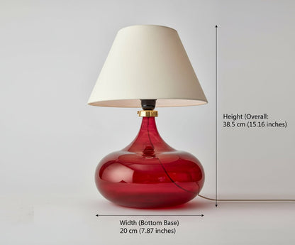 Table lamp with red base and white shade on a light gray background