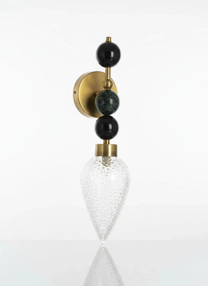 Decorative wall sconce with black and gold accents on a white background