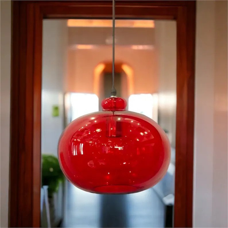 Red hand-blown glass pendant light in a modern hallway - Les Trois Pyramides