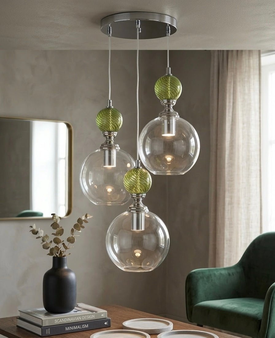 Modern pendant light fixtures with glass shades in a living room setting - Les Trois Pyramides