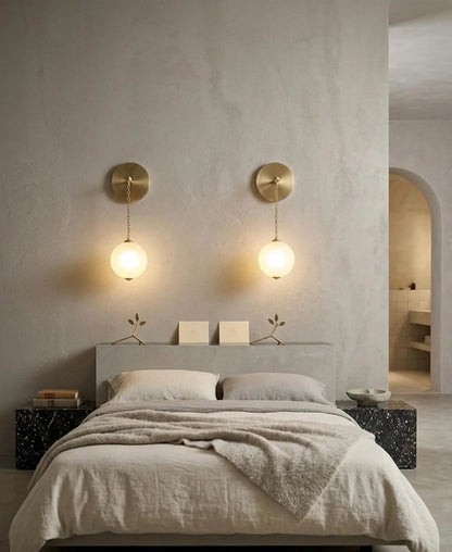 Modern bedroom with a bed, nightstands, and wall sconces.