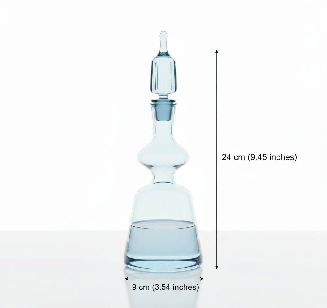 Clear glass decanter with wine glasses on a wooden table with a decorative background