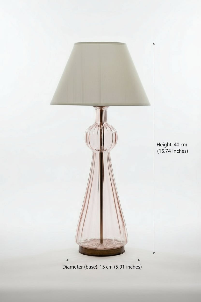 pink Lamp with a glass base and fabric shade on a white background