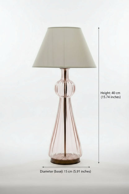 pink Lamp with a glass base and fabric shade on a white background