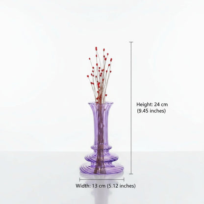 Purple glass vase with red decorative elements on a white background