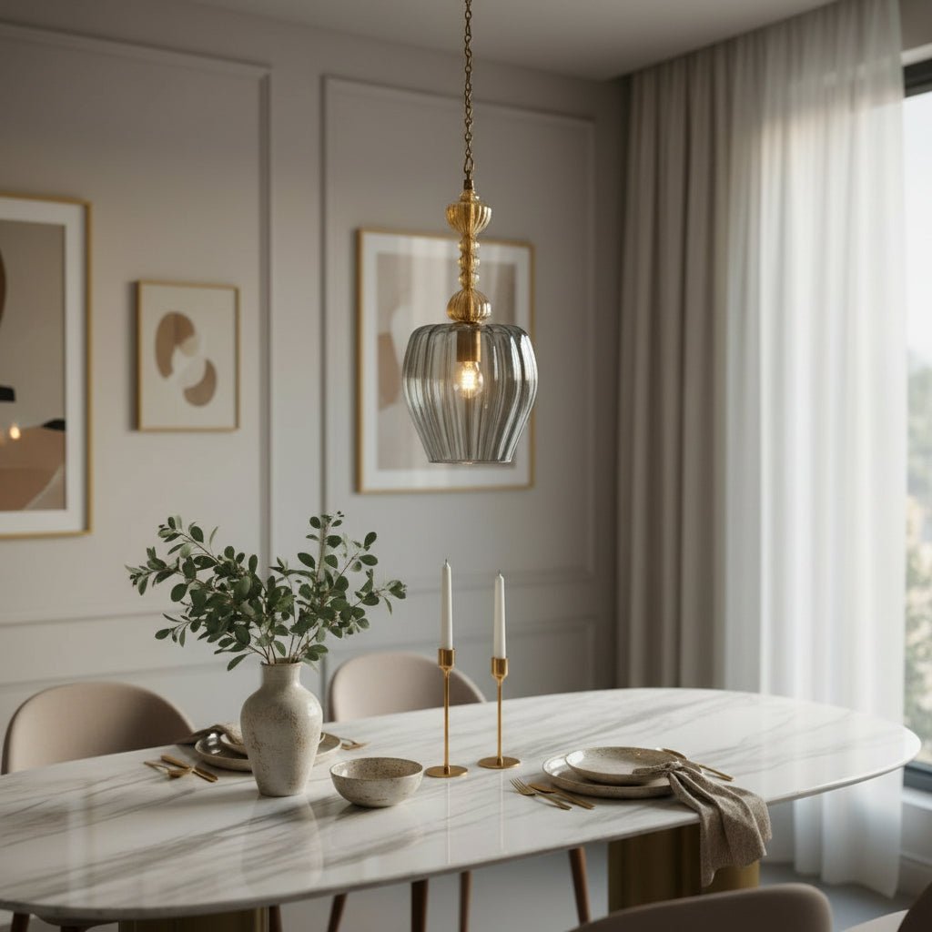 Decorative pendant light with glass shade and gold fixture in a room setting | Le Trois Pyramides